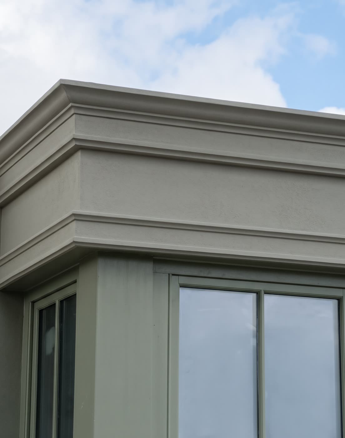 Plaster parapet moulding band along the top of a building