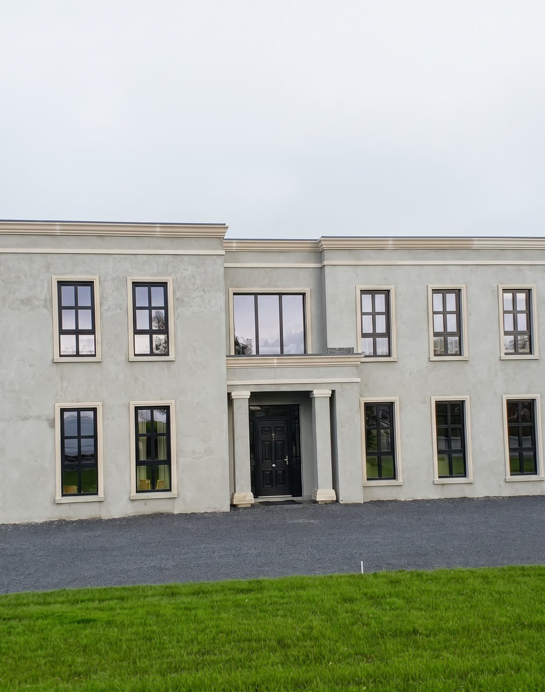 Parapet cappings along the roofline of a two-storey house